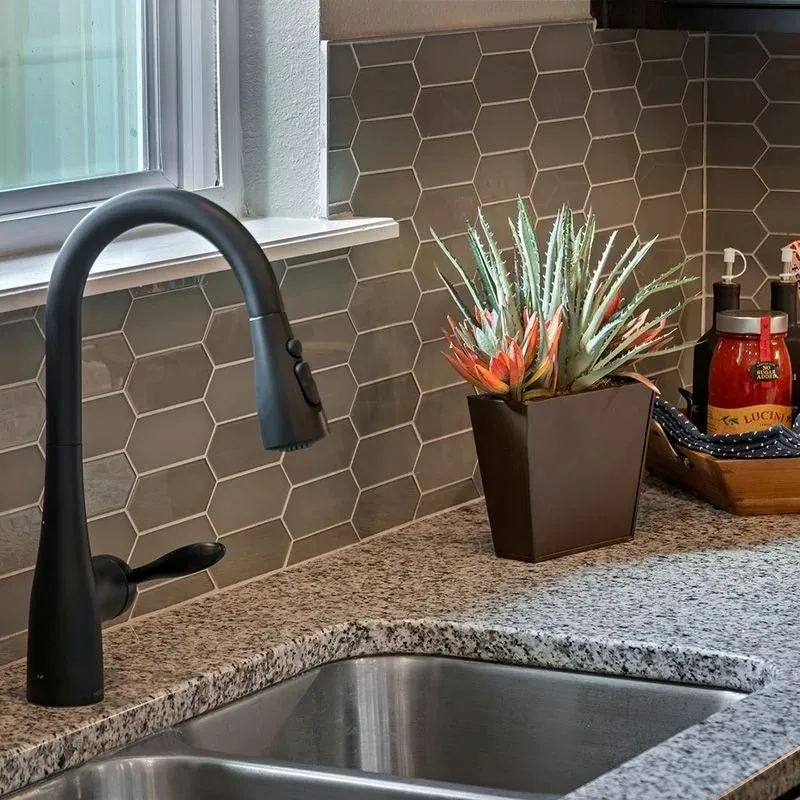 Kitchen sink with hexagonal tile backsplash