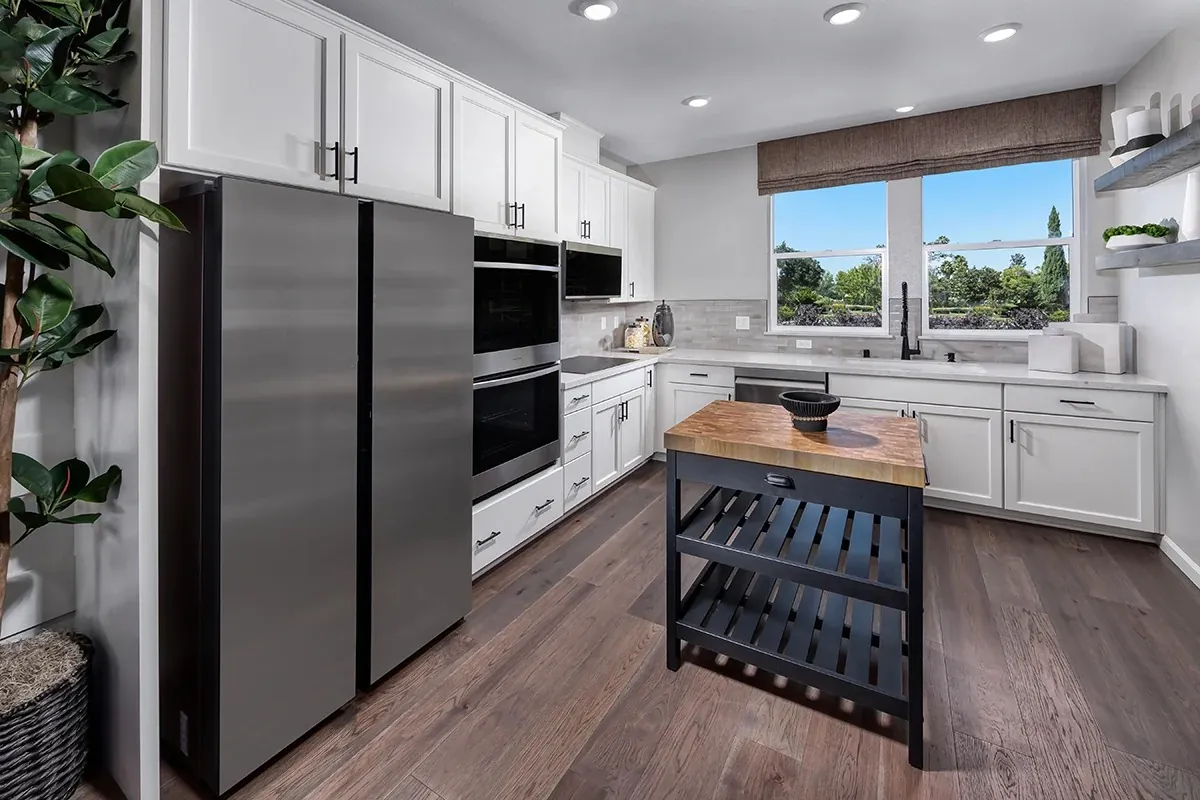Kitchen with white shaker cabinets and quartz counters